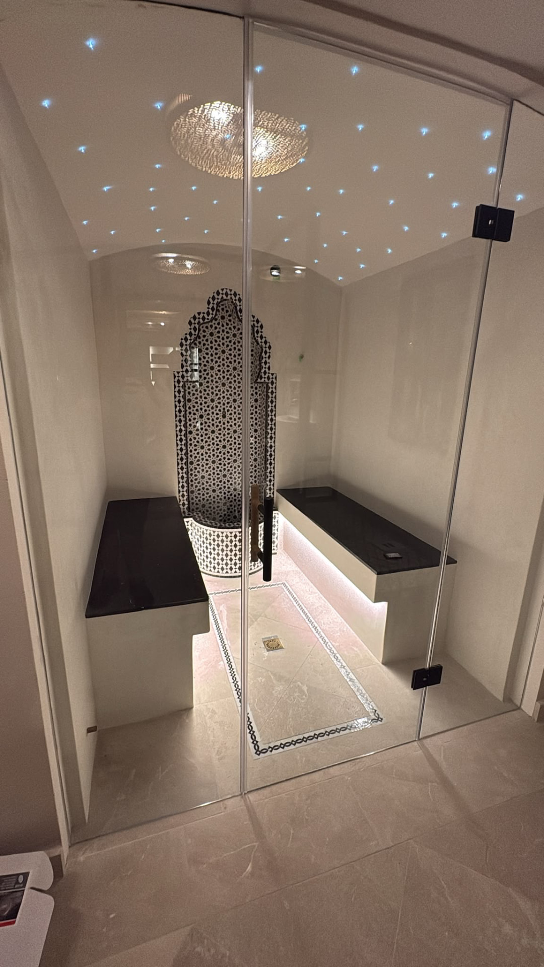 Hammam-style steam room with patterned tile fountain